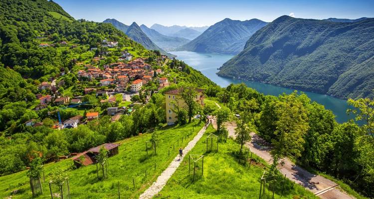 Beautiful lakeside village with mountains under a blue sky.