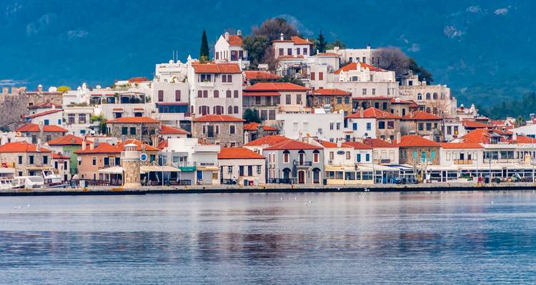 Charming coastal town with traditional architecture and red-tiled roofs by the sea.