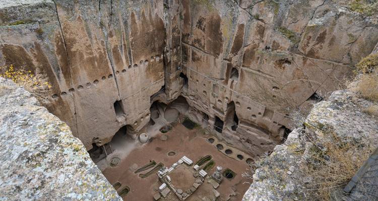 Ancient rock formations with carved dwellings.