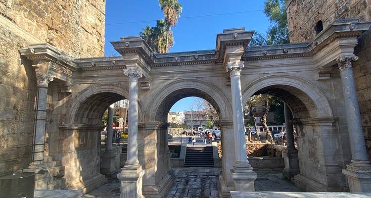 Historic Roman arch in a public square.