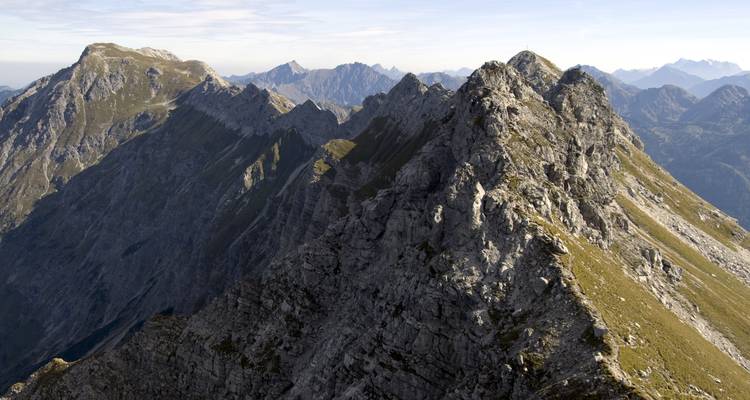 Panoramic view of rugged mountain peaks under a clear sky.