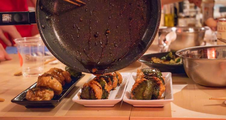 Scène de cuisine avec des brochettes en cours de préparation sur la table.