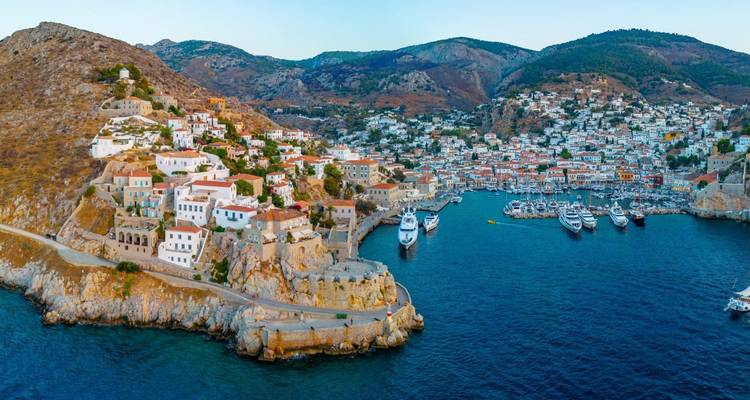 A serene harbor filled with yachts and traditional Greek houses.