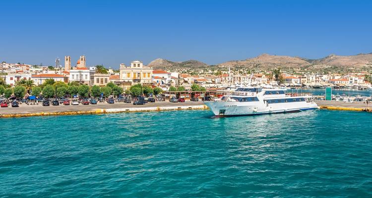 Harbor scene with a ferry and traditional architecture.