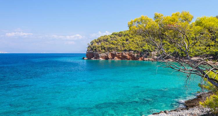 A scenic coastal area with turquoise waters and vegetation.
