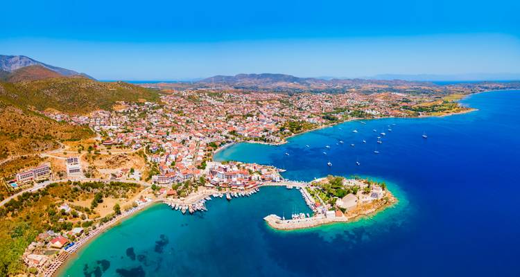 Panoramic view of a coastal city with a marina.