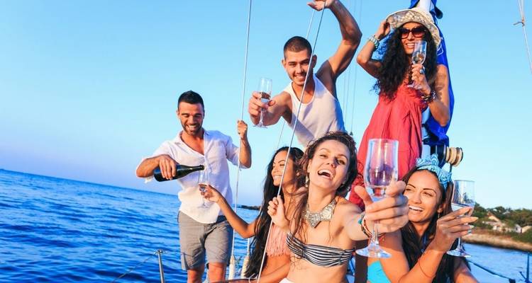 Group of young people enjoying a celebration on a boat.