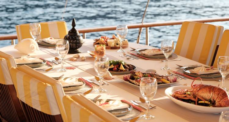 Table à manger élégante sur un bateau avec divers plats.