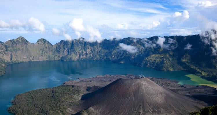 View of Mount Rinjani's volcano and lake surrounded by a caldera.