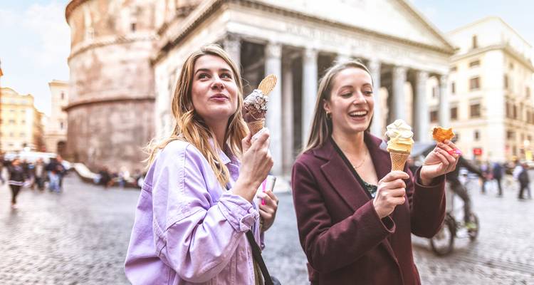 Two women eating ice cream in front of the Pantheon.