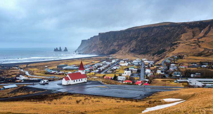 Village of Vik with sea stacks in the distance.