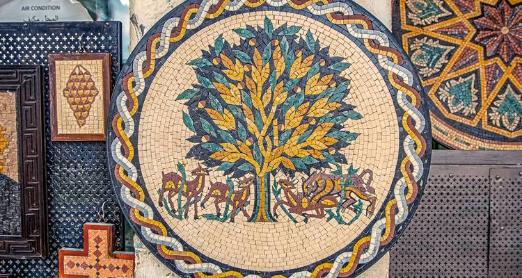 Mosaic art depicting a tree with camels.