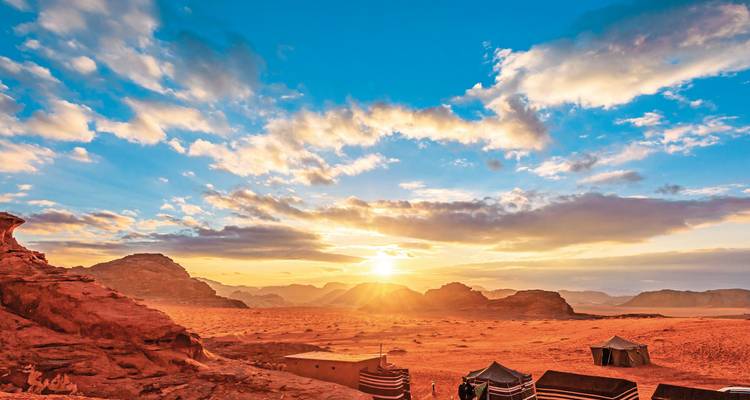 Wadi Rum desert landscape with a vibrant sunset.