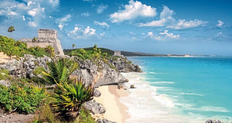 Tulum beach with Mayan ruins overlooking the ocean.