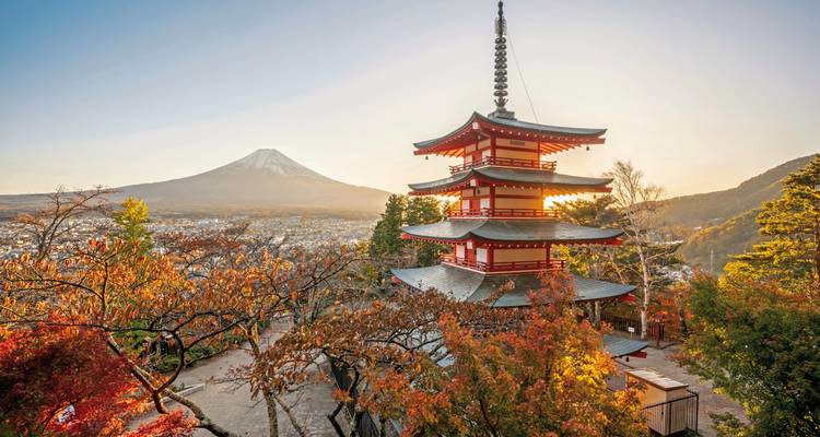A pagoda with Mount Fuji in the background, surrounded by autumn foliage.