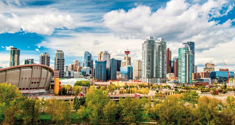 Distant view of Calgary's downtown skyline under a cloudy sky.