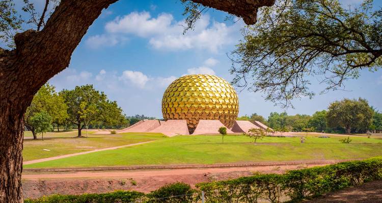 The Matrimandir at Auroville, a large golden dome in a landscaped setting.