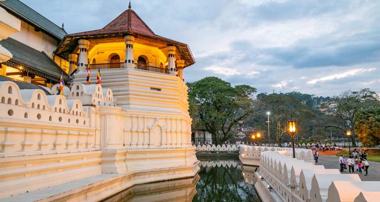 Temple of the Tooth in Kandy with surrounding trees.
