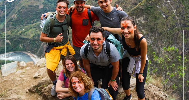 Group of hikers posing on a mountain trail.