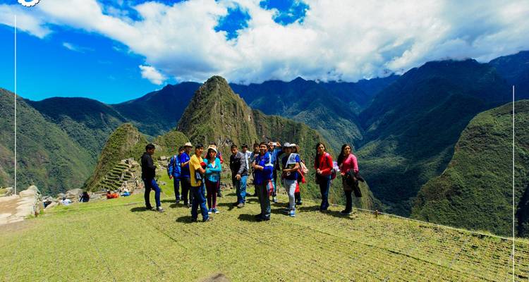 Group of tourists with Machu Picchu in the background.