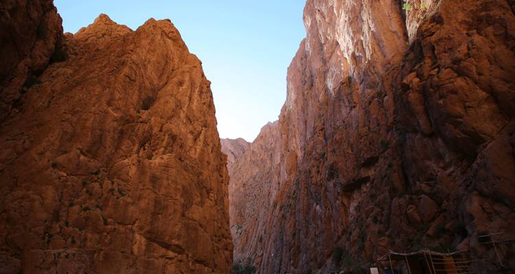 Rocky cliffs and a narrow gorge under a clear sky.