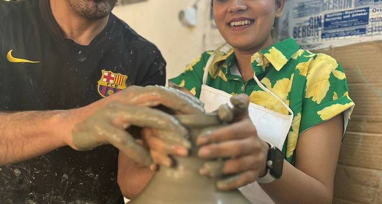 Two people engaged in pottery making