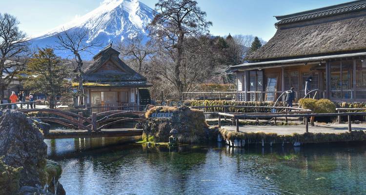 Village japonais traditionnel avec le mont Fuji en arrière-plan.