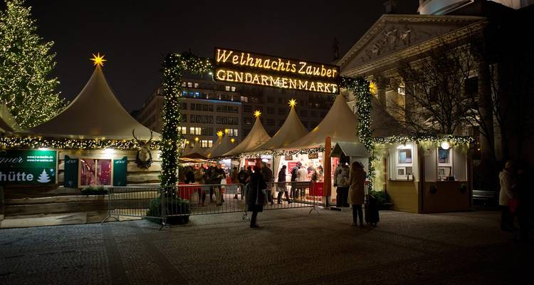 Entrance to a Christmas market with illuminated signs.