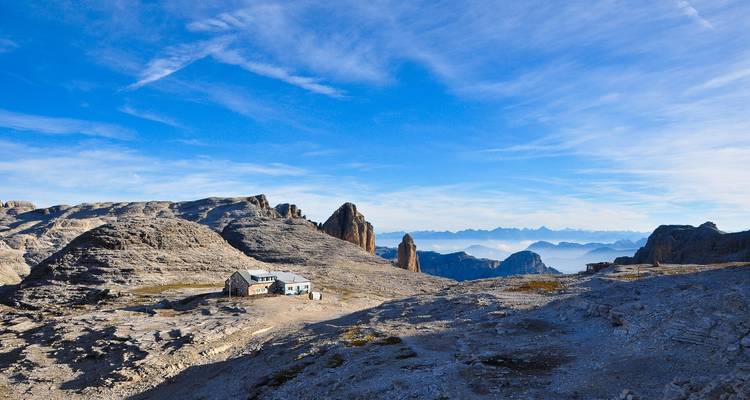 Mountain hut on a plateau with spectacular rocky formations.