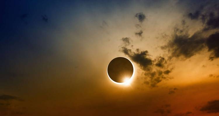 Solar eclipse with dramatic cloud cover.