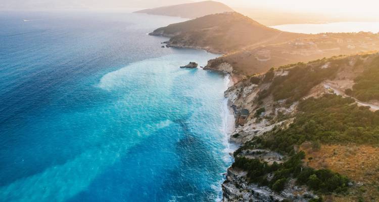 Aerial view of coastline with clear turquoise waters.