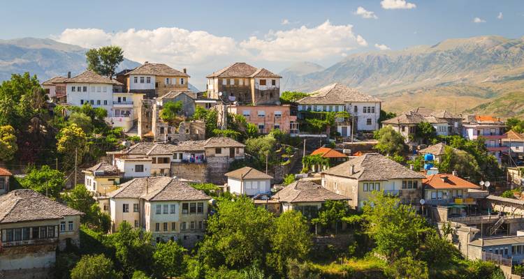 Gjirokastra town with traditional stone houses and mountains around.