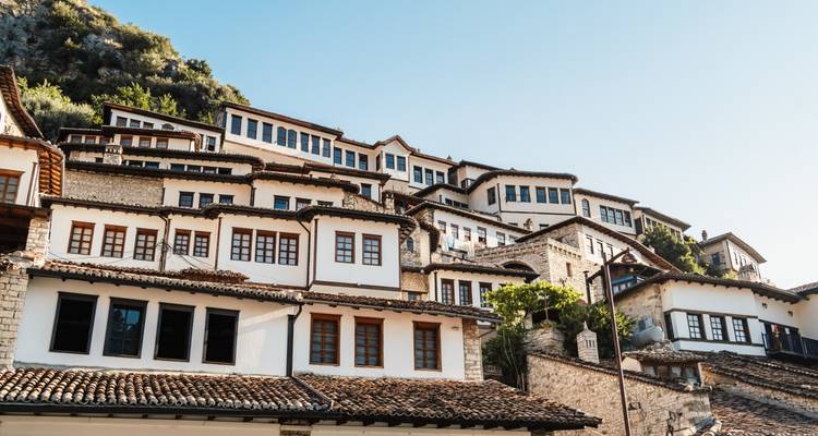 Cluster of historical white houses with brown roofs on a hill