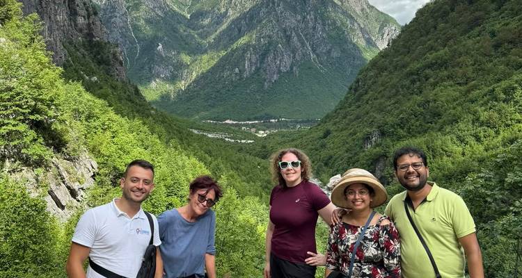Group of people posing in scenic mountainous landscape