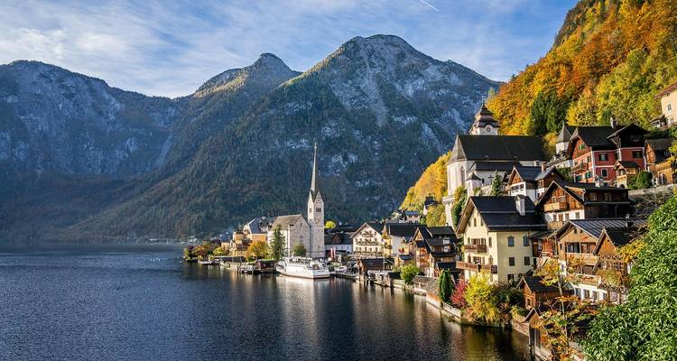 Scenic view of Hallstatt by the lake surrounded by mountains.