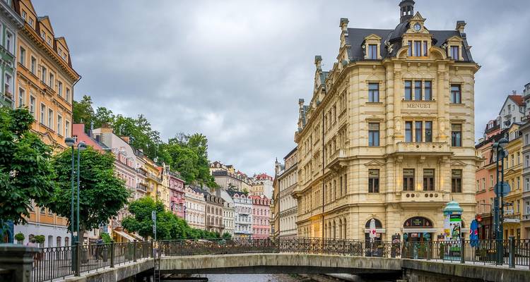 Colorful buildings lining a canal in a historic city center.