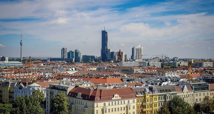 Cityscape of Vienna with modern skyscrapers and historic buildings.