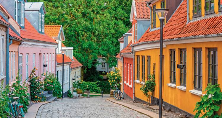 Colorful historic houses along a cobblestone street.