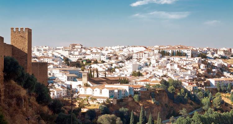 White-washed village surrounded by rolling hills.
