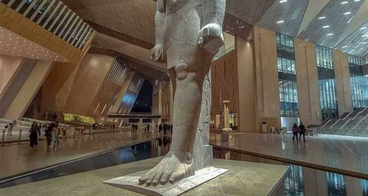 Ancient statue foot in a spacious modern interior