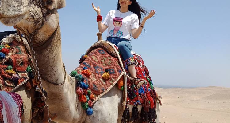 Woman on a decorated camel in the desert