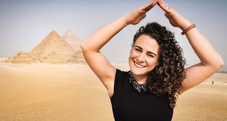 Smiling woman posing in front of pyramids