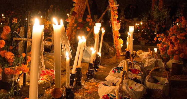 Kerzen und Ringelblumen während einer nächtlichen Feier.