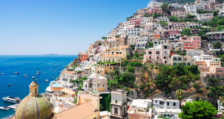 Iconic panoramic view of Positano’s cascading pastel buildings against a deep blue Mediterranean backdrop.