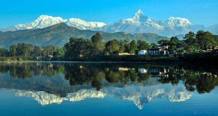 Reflection of snow-capped mountains in a still lake.