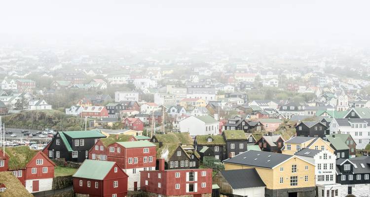 Foggy view of a city with colorful houses.