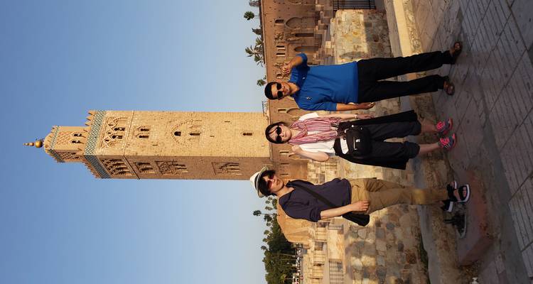Groupe de touristes devant une tour historique.