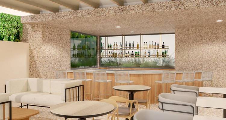 Zona de bar moderna con asientos y una variedad de botellas en exhibición.