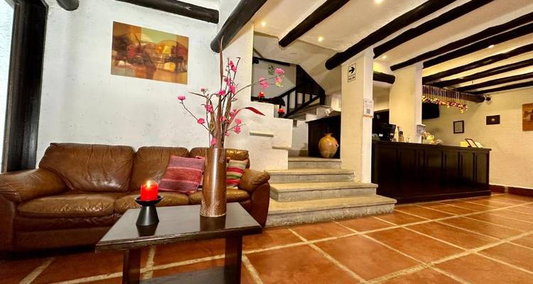 Cozy hotel lobby with seating and a decorative touch.