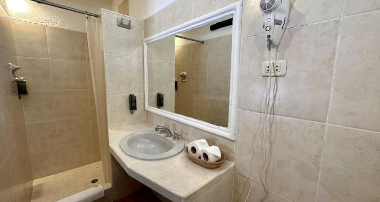 Simple bathroom with a shower and sink.